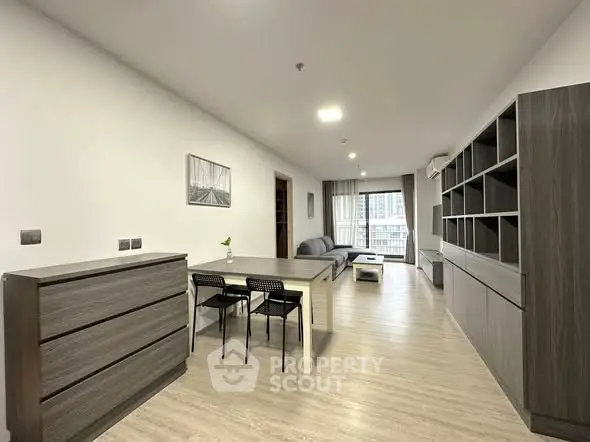 Spacious modern living room with open layout and stylish furniture in a high-rise apartment.