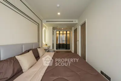 Modern bedroom with elegant decor and cozy ambiance, featuring a large bed and stylish lighting.