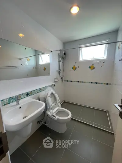 Modern bathroom with sleek fixtures and decorative tile accents