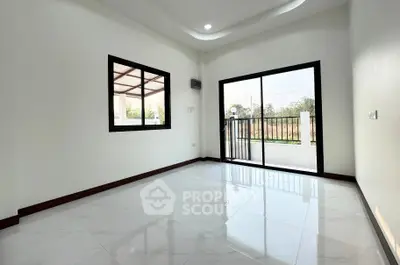 Spacious empty room with large window and balcony access, perfect for customization.