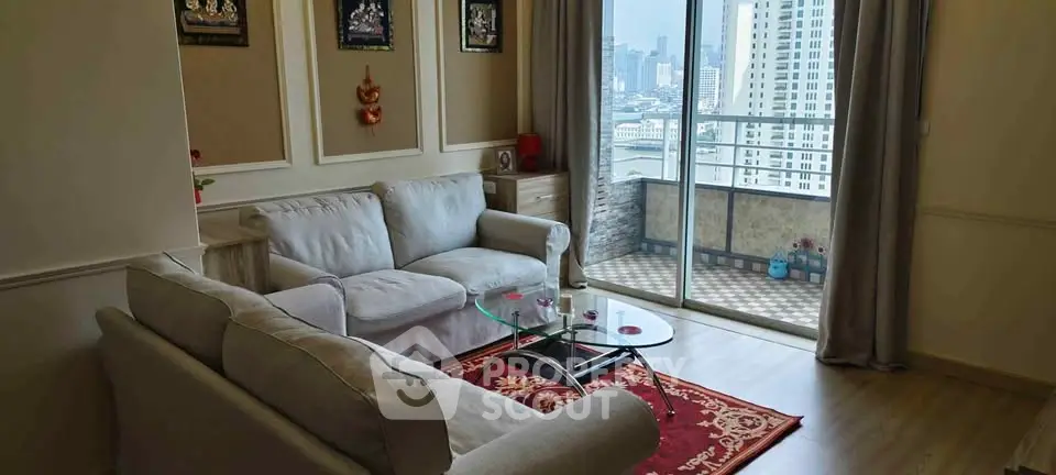 Spacious living room with cozy sofas and city view balcony in modern apartment.