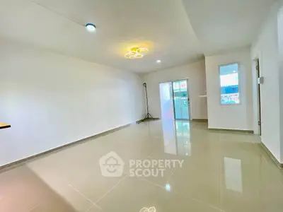 Spacious modern living room with glossy tiled floors and contemporary lighting