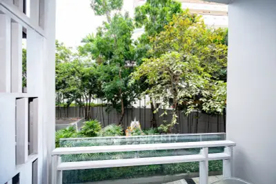 Charming balcony view with lush greenery and modern railing design.