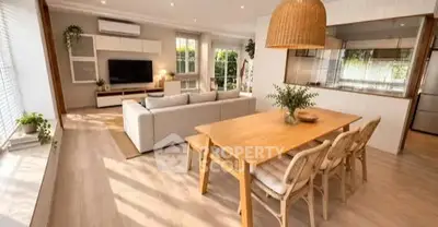 Spacious open-plan living and dining area with modern decor and natural light.