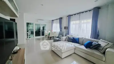 Spacious modern living room with elegant decor and large windows for natural light.