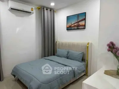 Cozy bedroom with modern decor and air conditioning in a stylish apartment.