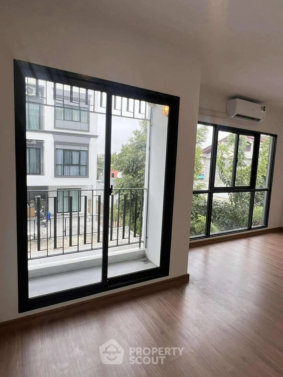 Spacious modern apartment with large windows and balcony view