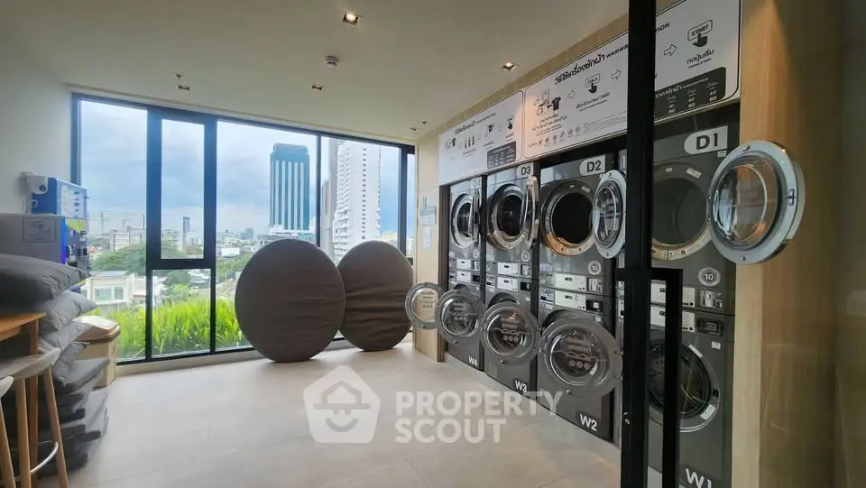 Modern laundry room with city view in high-rise building