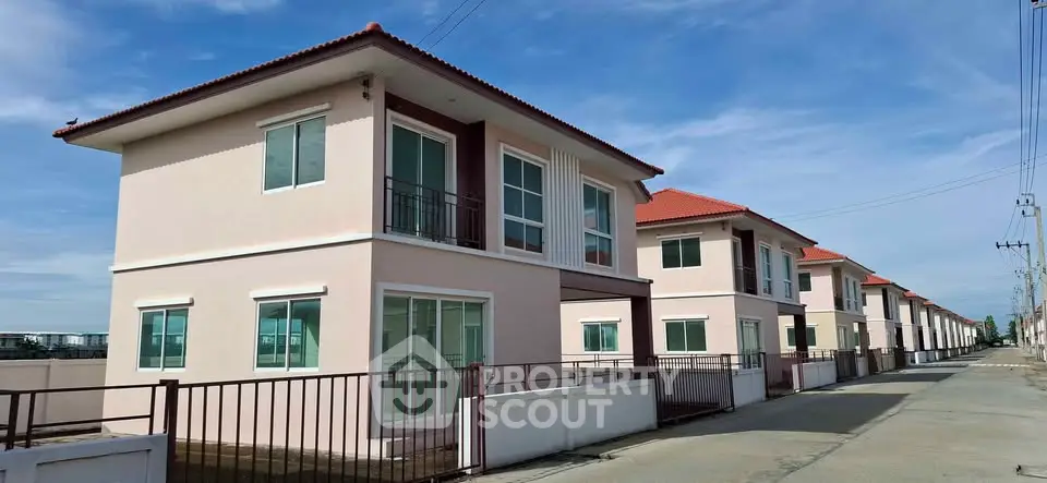 Modern two-story houses with red roofs in a suburban neighborhood, showcasing contemporary architecture and spacious layout.
