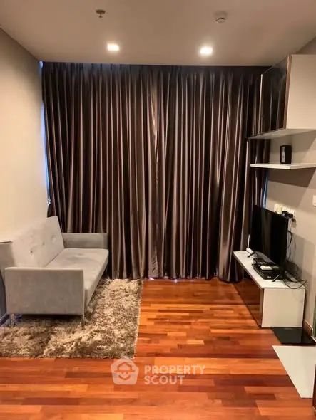 Cozy living room with elegant curtains and modern furniture in a stylish apartment.