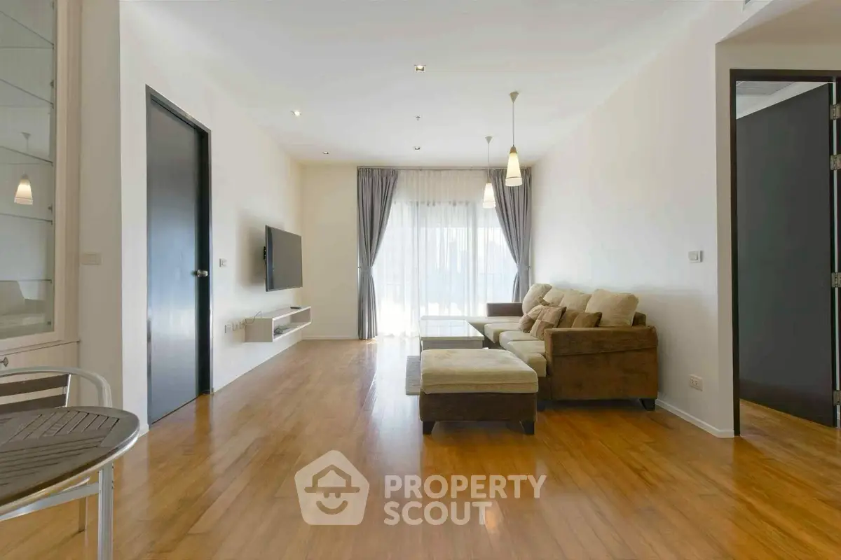 Spacious modern living room with wooden flooring and cozy seating area