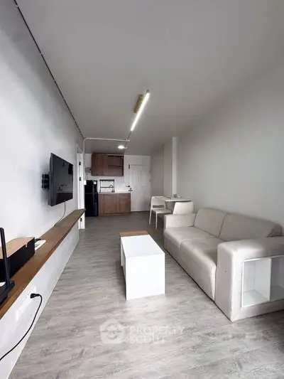 Modern living room with sleek design and open kitchen layout