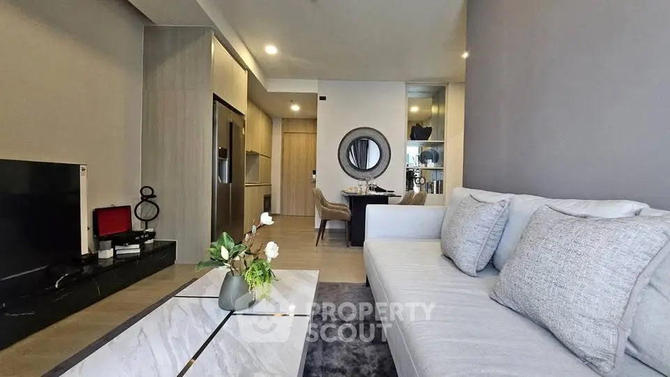 Modern living room with sleek design and open kitchen layout