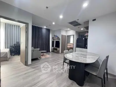 Modern open-plan living and dining area with sleek furniture and stylish decor.