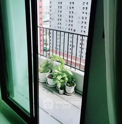 Charming balcony with potted plants and city view, perfect for relaxation.