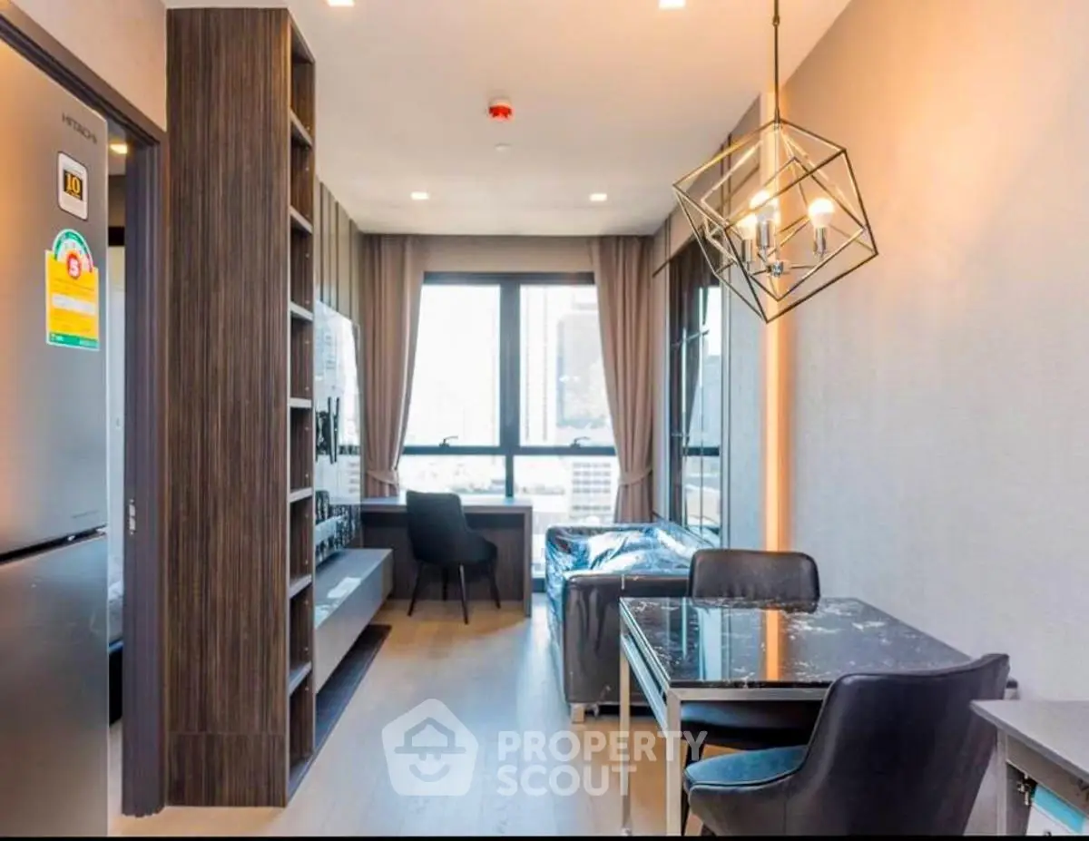 Modern living room with stylish decor and large window offering city views