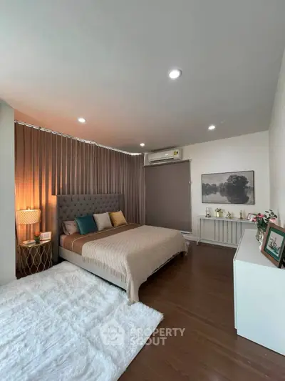 Spacious modern bedroom with elegant decor and cozy lighting
