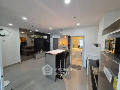 Modern kitchen with sleek design and open layout, featuring a breakfast bar and contemporary appliances.