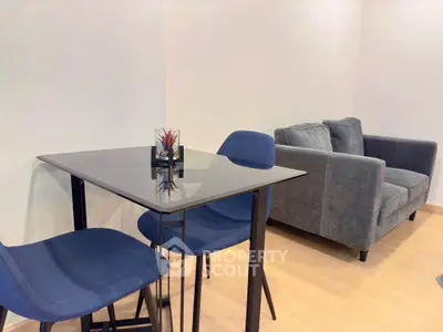 Modern living room with stylish blue chairs and sleek glass table