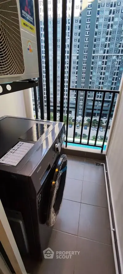 Modern apartment balcony with washing machine and city view