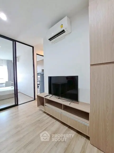 Modern living room with sleek TV stand and air conditioning unit