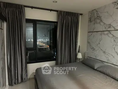 Luxurious bedroom with city view and elegant marble accents