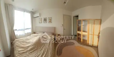 Cozy bedroom with modern decor, featuring a large window, stylish bed, and elegant artwork on the walls.