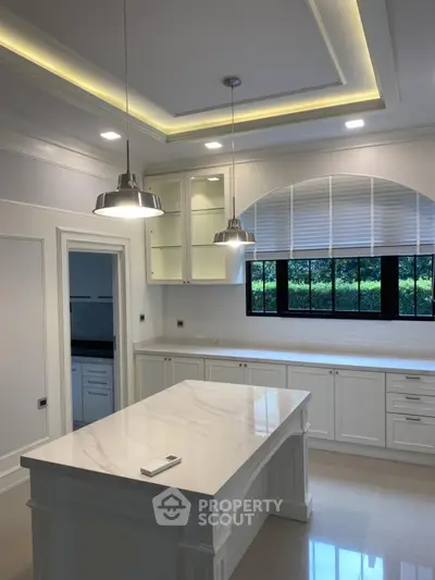 Luxurious modern kitchen with elegant island and stylish lighting