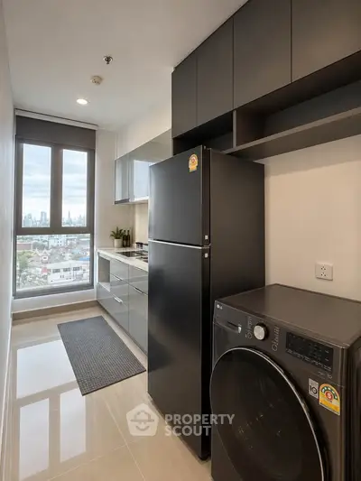Modern kitchen with sleek appliances and city view from window