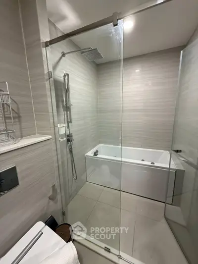 Modern bathroom with glass shower and bathtub in sleek design