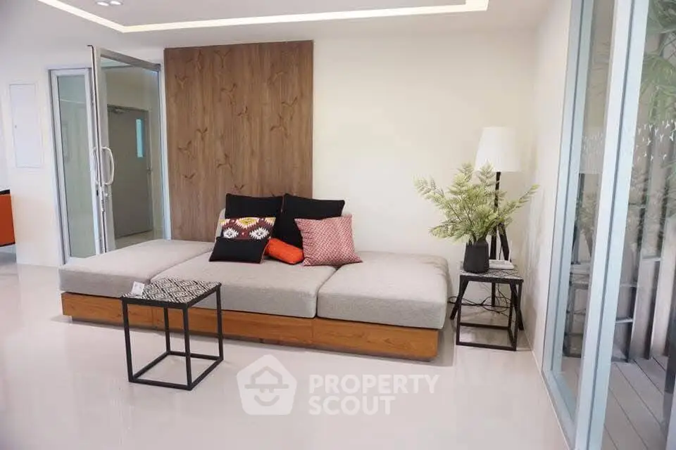 Modern living room with stylish sofa and elegant decor in a bright, open space.