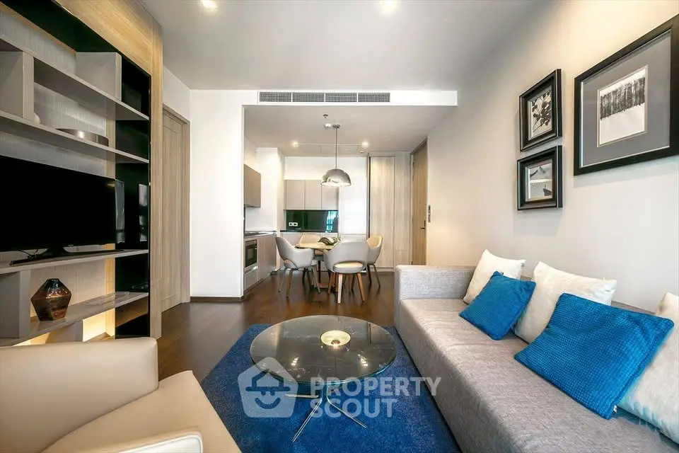 Modern living room with stylish decor and open kitchen layout in a contemporary apartment.