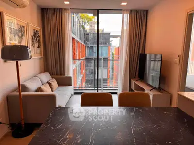 Modern living room with large window and stylish decor in urban apartment