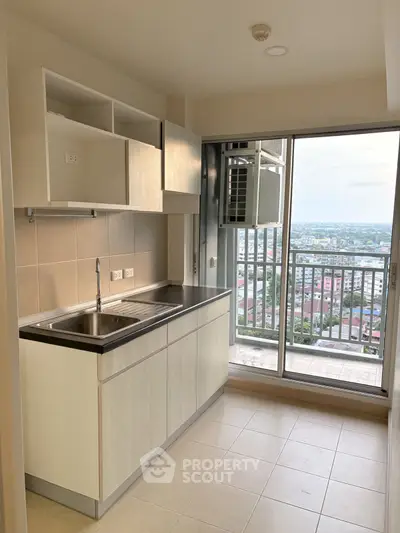 Modern kitchen with balcony view in high-rise apartment