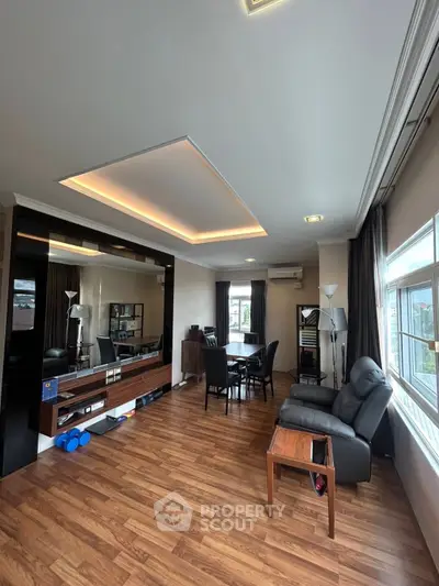 Spacious living room with modern decor and large windows for natural light.