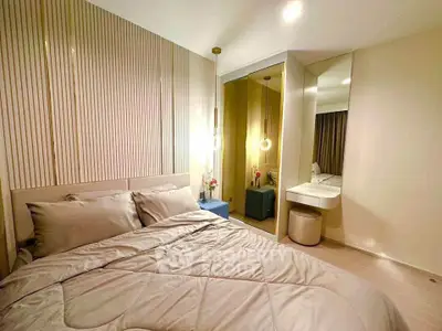 Modern bedroom with stylish decor and cozy ambiance, featuring elegant lighting and a comfortable bed.