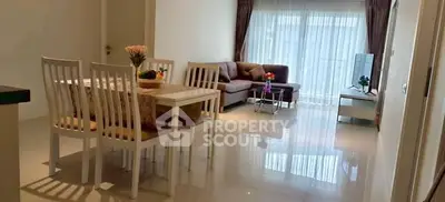 Spacious living room with elegant dining area and cozy seating arrangement.