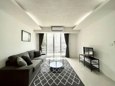 Modern living room with sleek furniture and natural light, perfect for relaxation.