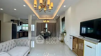 Luxurious open-plan living room with elegant decor and modern kitchen.