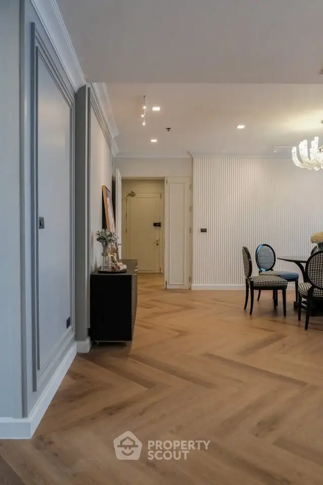 Elegant dining area with herringbone wood flooring and modern decor