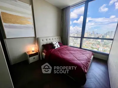 Luxurious bedroom with stunning city view and elegant decor in modern high-rise apartment.