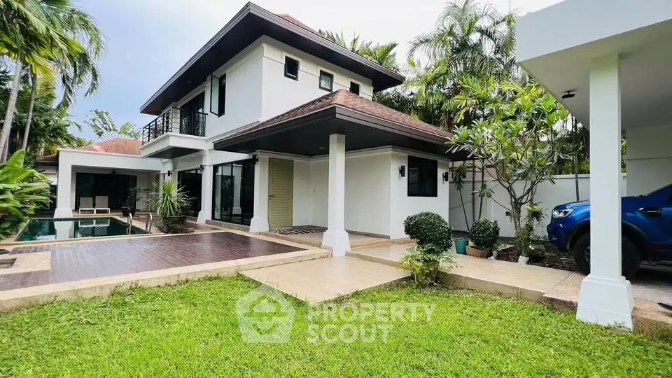 Luxurious modern villa with private pool and lush garden in tropical setting.