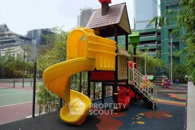 Vibrant playground with slide in urban residential complex