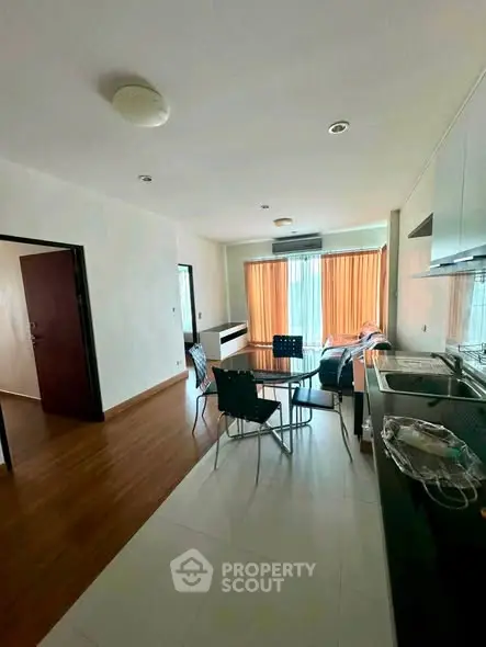 Spacious open-layout kitchen and dining area with modern furnishings and natural light.