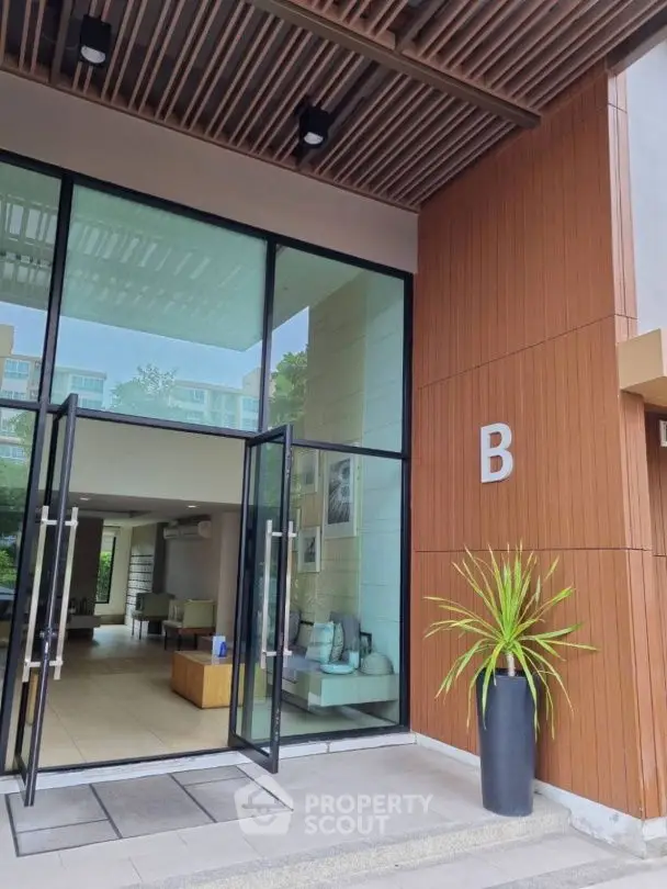 Modern building entrance with glass doors and stylish decor