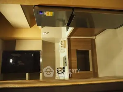 Modern kitchen with sleek appliances and stylish cabinetry in a compact layout.