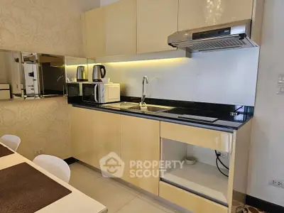 Modern kitchen with sleek cabinetry and integrated appliances in a stylish apartment.