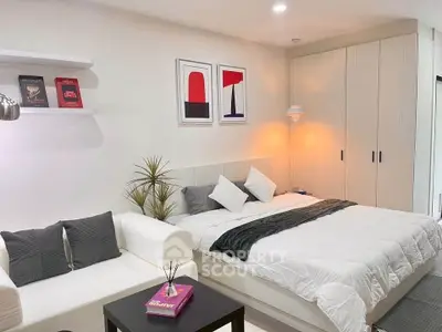 Modern bedroom with cozy seating area and stylish decor