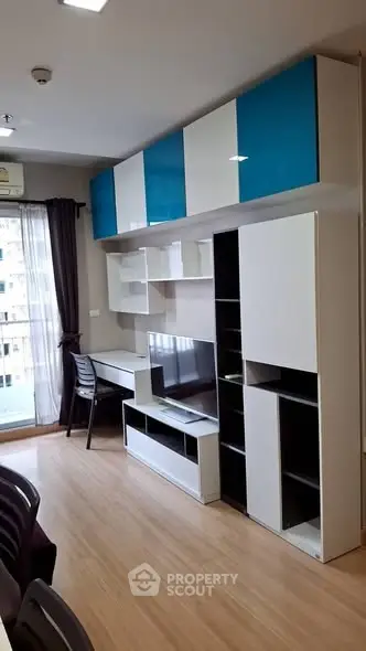 Modern study room with sleek storage and natural light in a stylish apartment.