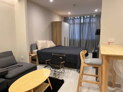 Modern studio apartment with cozy furnishings and natural light